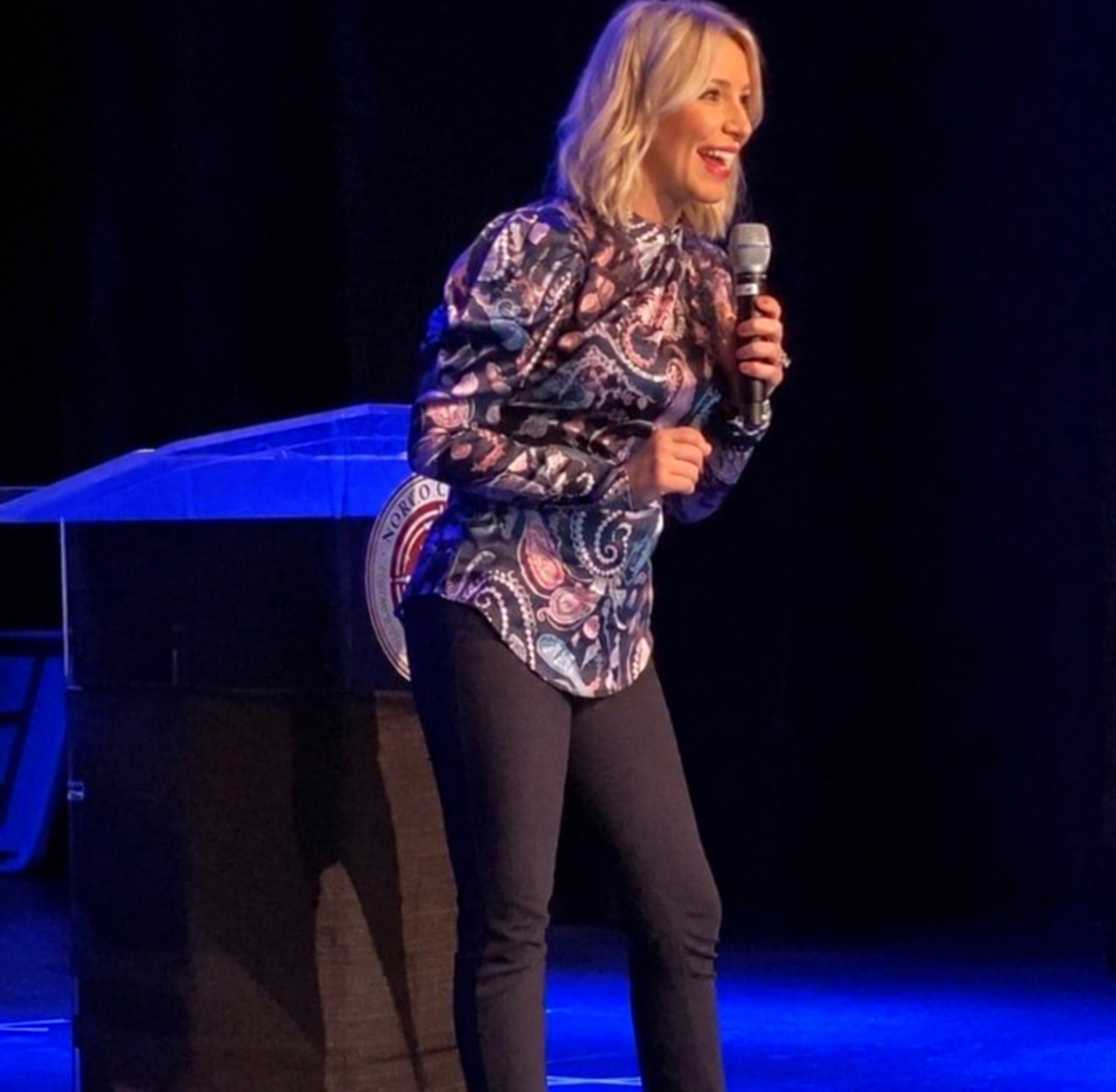 Tara Oldridge speaking at a podium